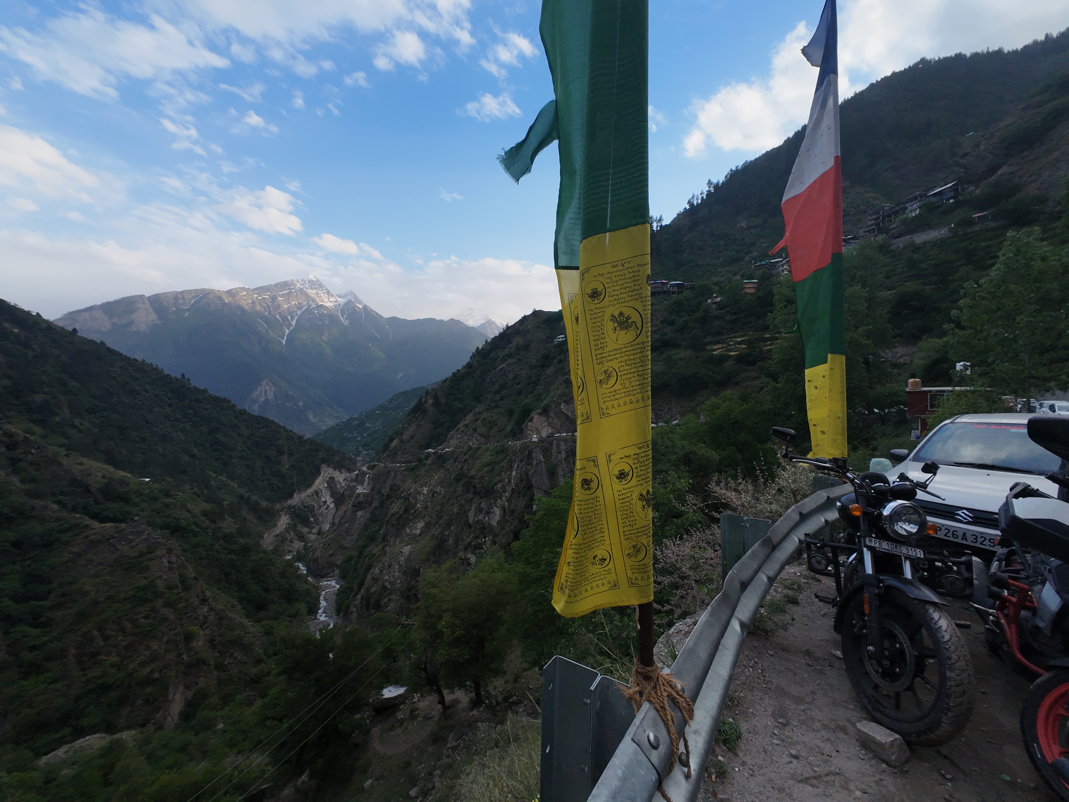Prayer flags fluttering at a viewpoint on the Yulla Kanda trek with deep valley below